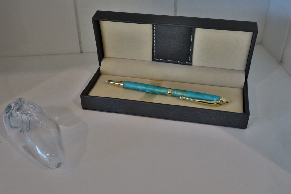Handmade aqua marbled click pencil displayed in a presentation case
