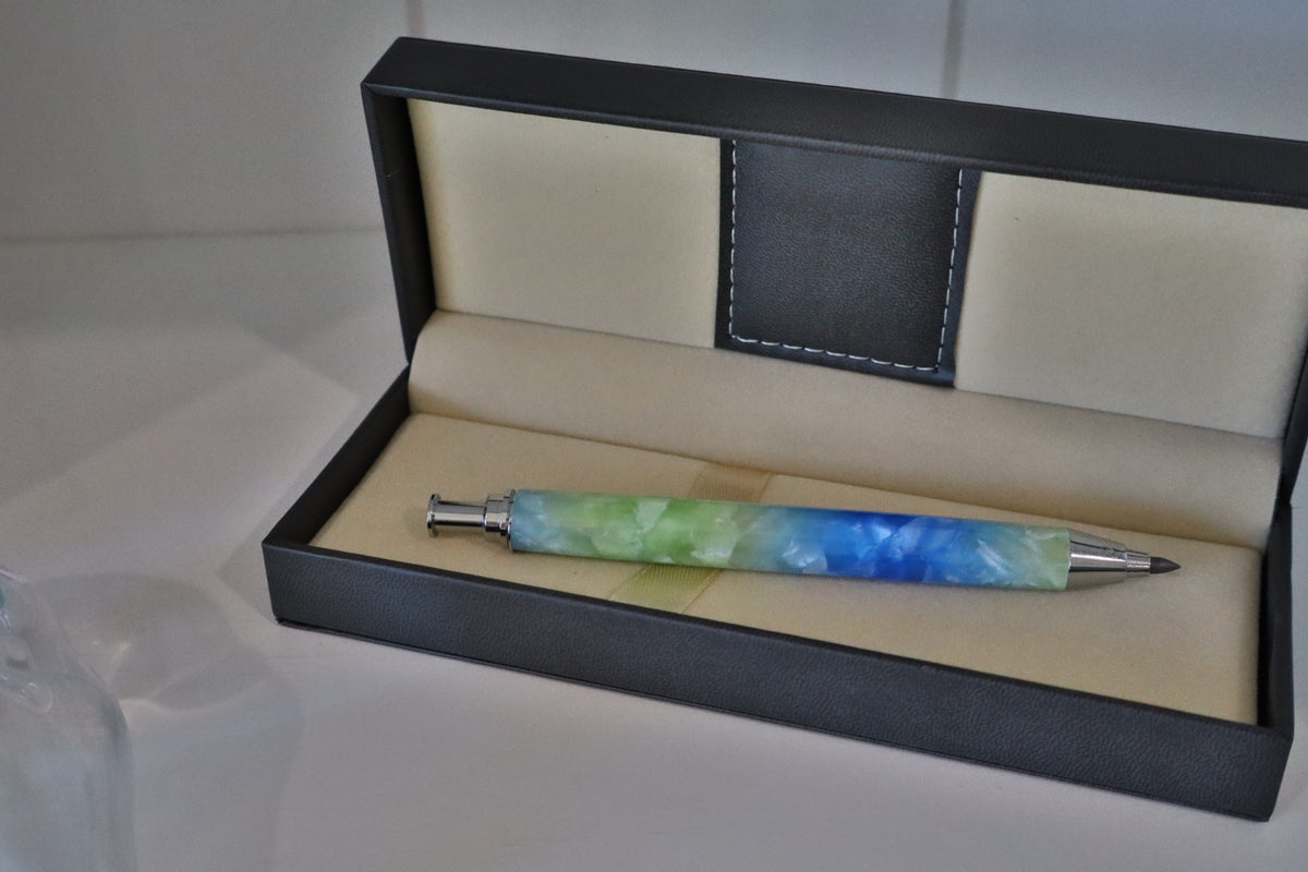 Handmade blue and green marbled 5.6 mm artist clutch pencil shown from the side